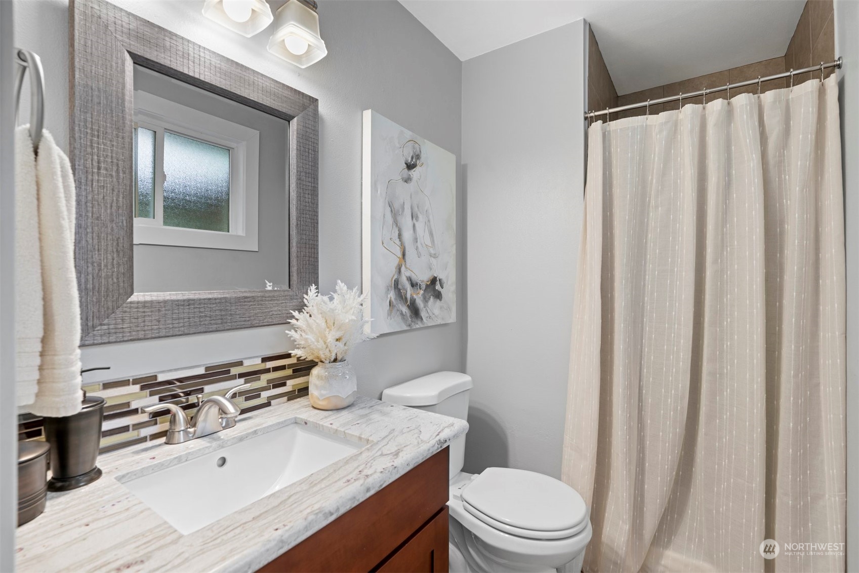 24301 7th Place West Bothell, WA 98021 - Photo 14 of 40 a bathroom with a sink a toilet and shower curtain