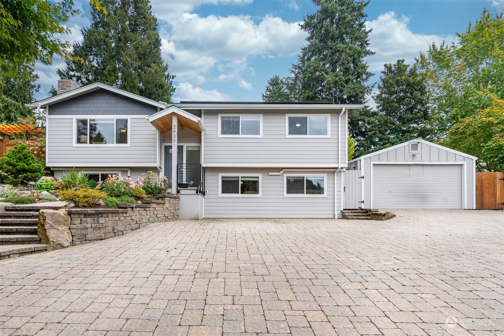 24301 7th Place West Bothell, WA 98021 - Photo 2 of 40 a front view of house with yard and trees in the background