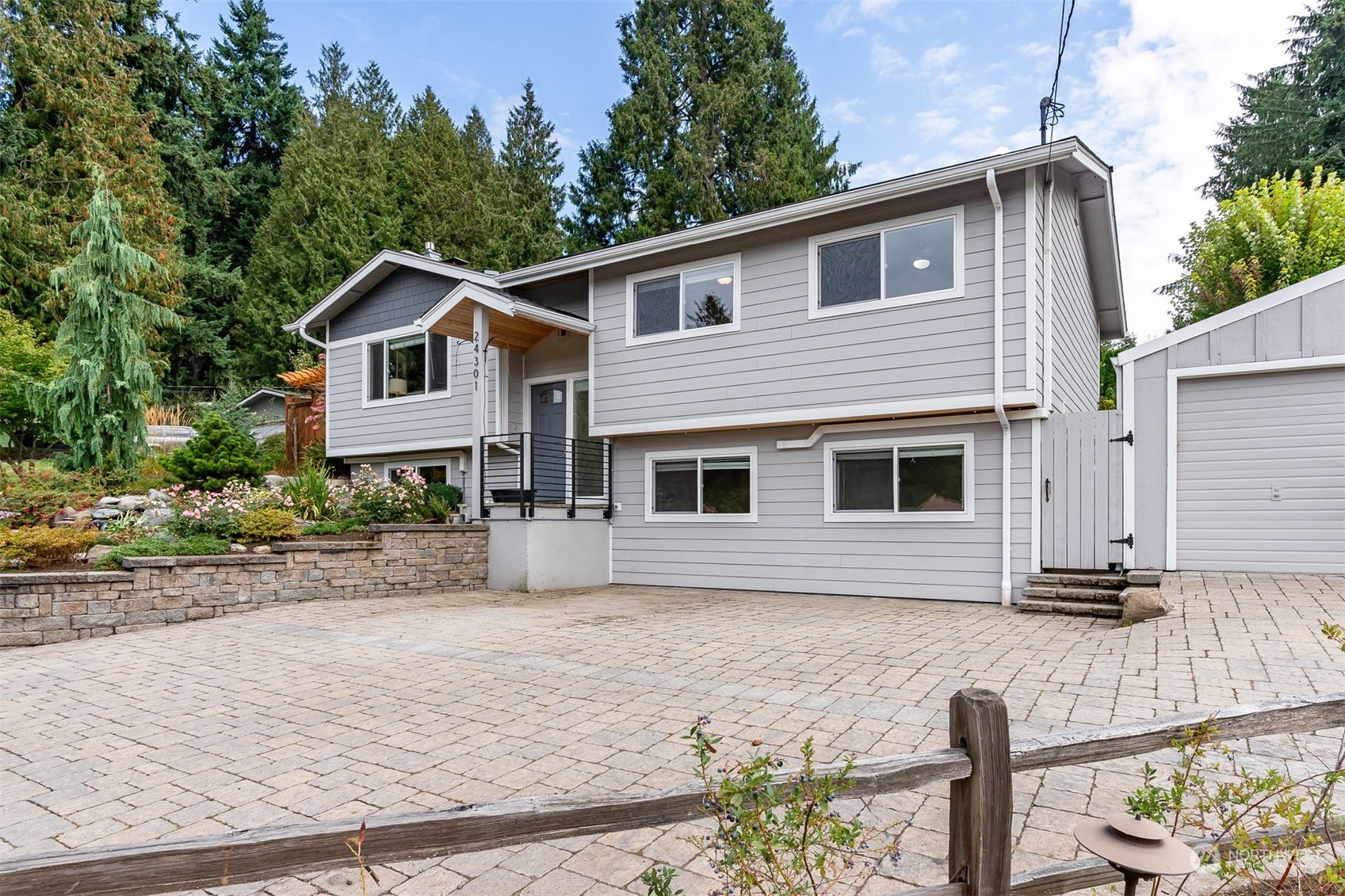 24301 7th Place West Bothell, WA 98021 - Photo 3 of 40 a front view of a house with garden