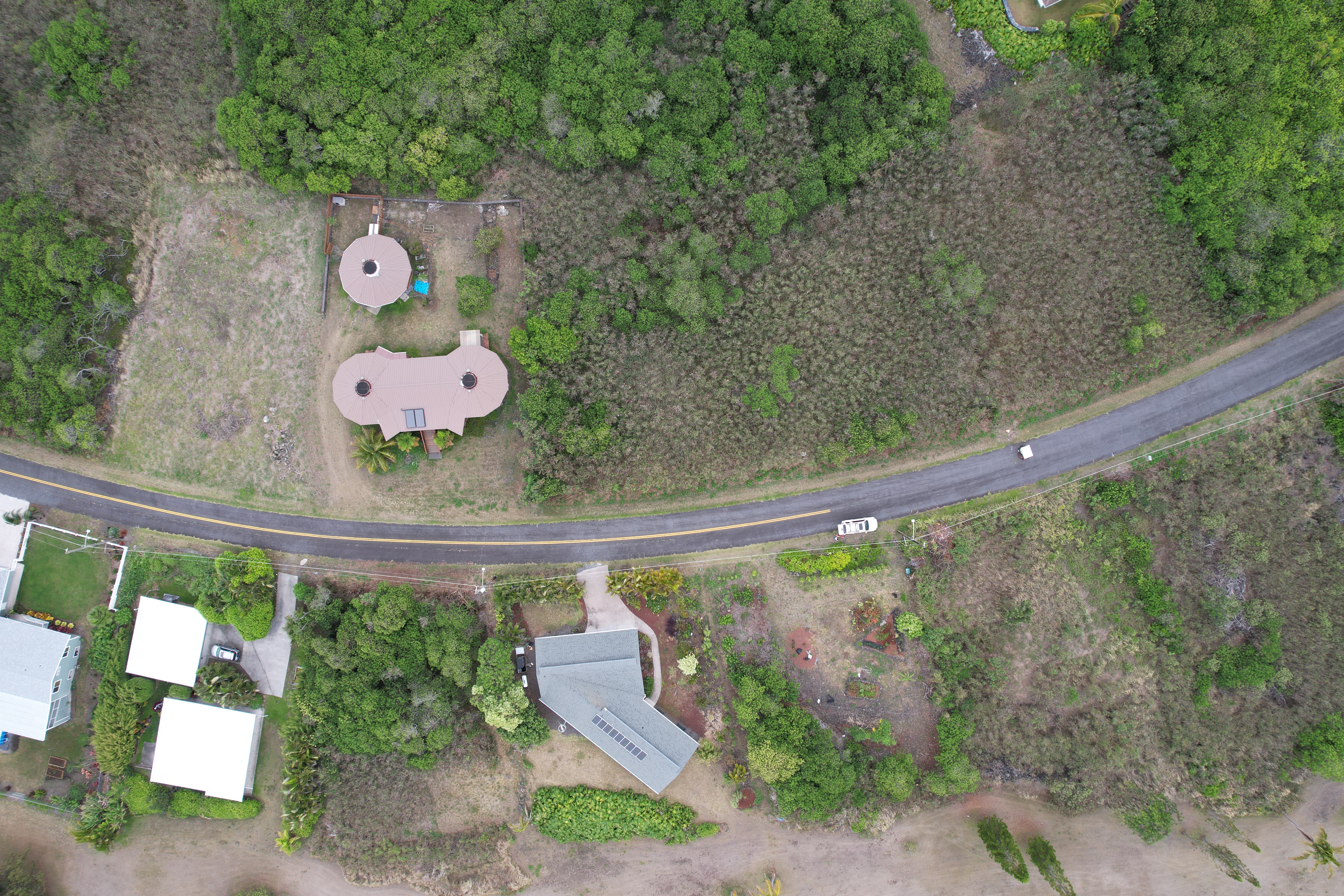 115 Kaulua Circle Naalehu, HI 96772 - Photo 2 of 9 a wooden floor with some trees in the background