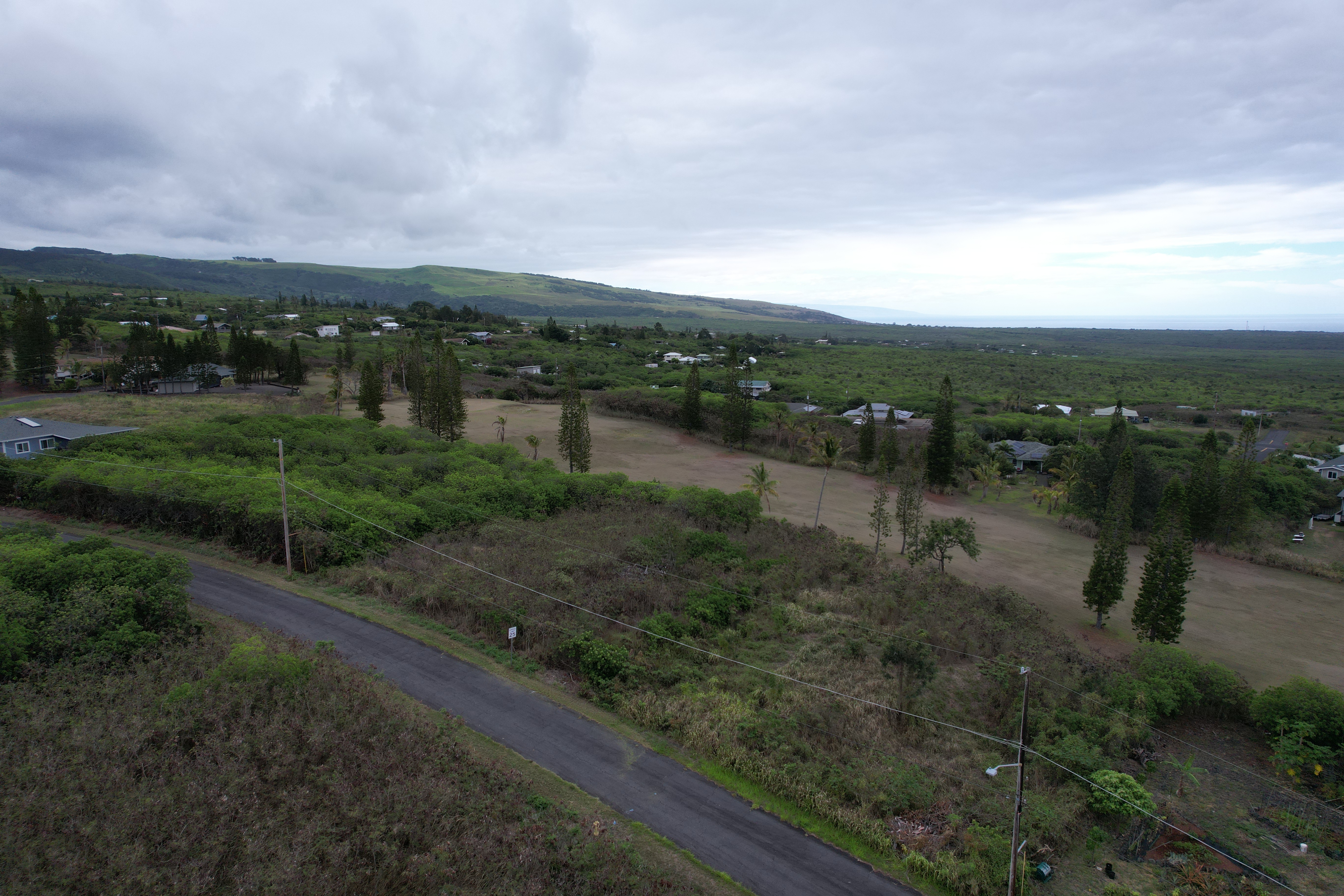 115 Kaulua Circle Naalehu, HI 96772 - Photo 6 of 9 a view of a lake with houses in back