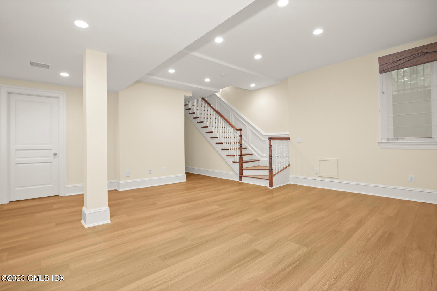 100 East Elm Street, Unit 1 Greenwich, CT 06830 - Photo 18 of 27 a view of an empty room with wooden floor and stairs