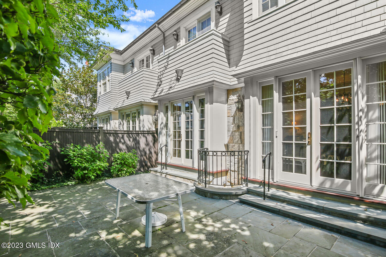 100 East Elm Street, Unit 1 Greenwich, CT 06830 - Photo 22 of 27 a front view of a house with a garden