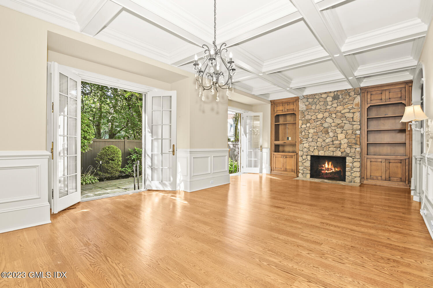 100 East Elm Street, Unit 1 Greenwich, CT 06830 - Photo 5 of 27 a view of an empty room with wooden floor fireplace and a window