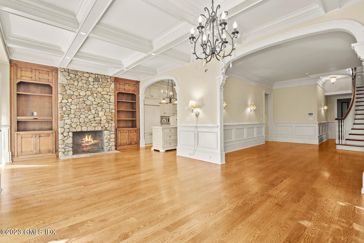 100 East Elm Street, Unit 1 Greenwich, CT 06830 - Photo 7 of 27 a view of an empty room with a fireplace and chandelier