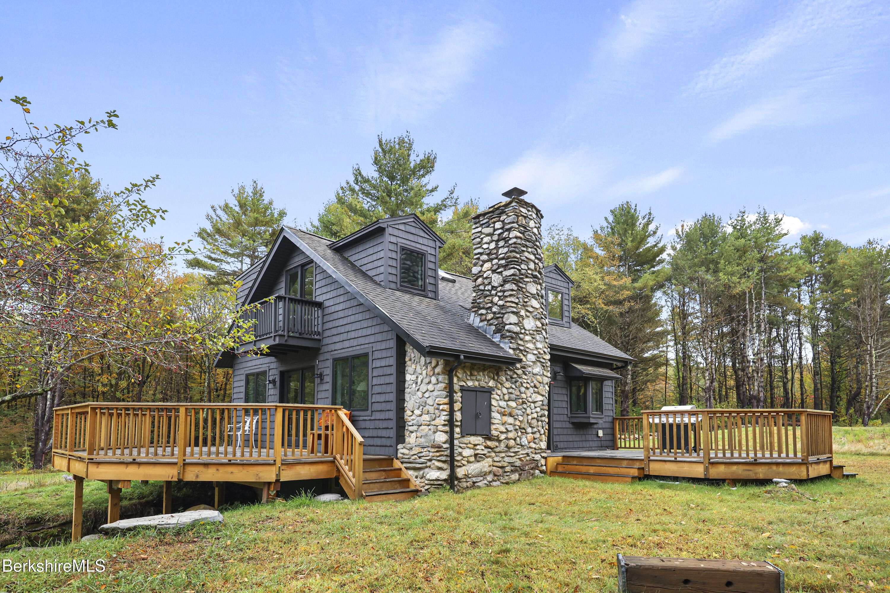 327 Chester Road Becket, MA 01223 - Photo 7 of 49 a view of a house with backyard wooden deck and a garden