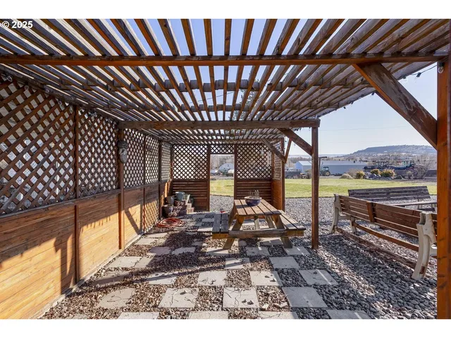 a backyard of a house with table and chairs