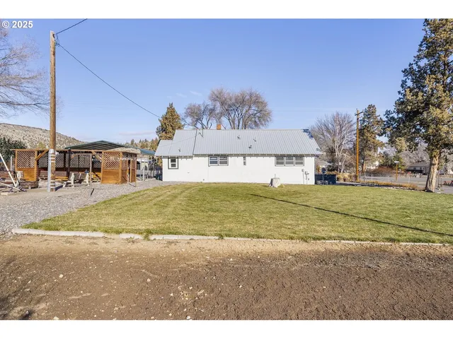a backyard of a house with barbeque oven