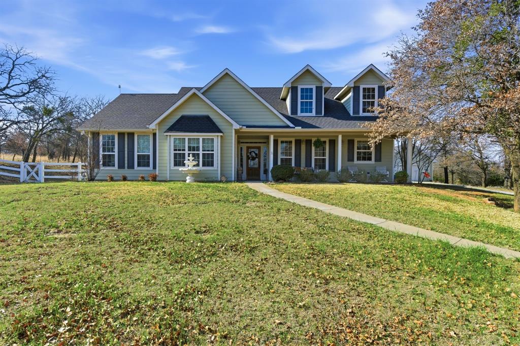 240 Johnson Bend Road Weatherford, TX 76088 - Photo 2 of 40 a front view of a house with a garden and trees