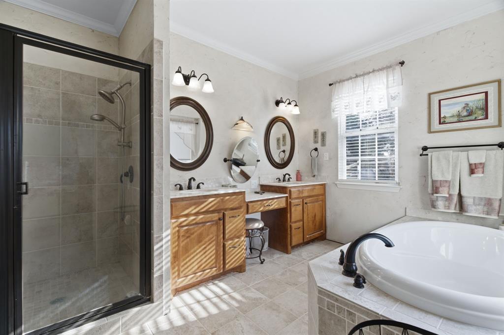 240 Johnson Bend Road Weatherford, TX 76088 - Photo 21 of 40 a bathroom with a tub sink and mirror