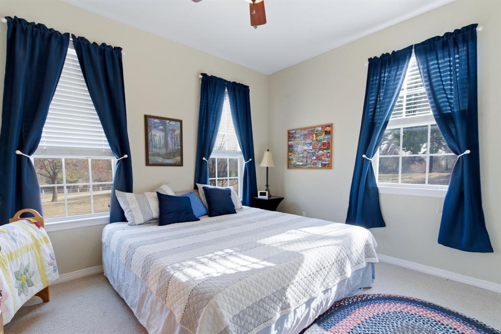 240 Johnson Bend Road Weatherford, TX 76088 - Photo 26 of 40 a bedroom with a bed and a large window