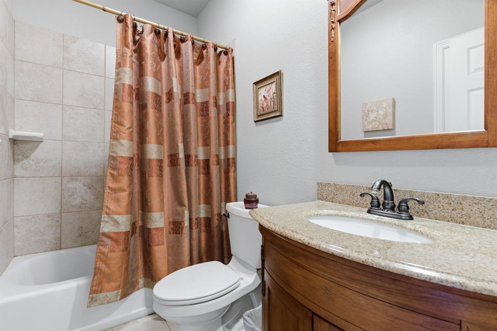 240 Johnson Bend Road Weatherford, TX 76088 - Photo 27 of 40 a bathroom with a granite countertop sink toilet and shower