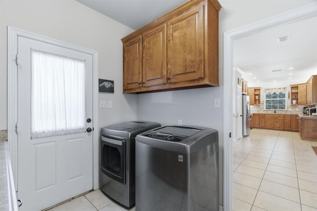 240 Johnson Bend Road Weatherford, TX 76088 - Photo 28 of 40 a kitchen with stainless steel appliances granite countertop a stove a sink and a refrigerator