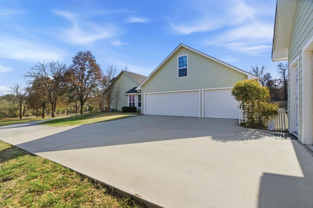 240 Johnson Bend Road Weatherford, TX 76088 - Photo 34 of 40 a view of a house with a yard and garage