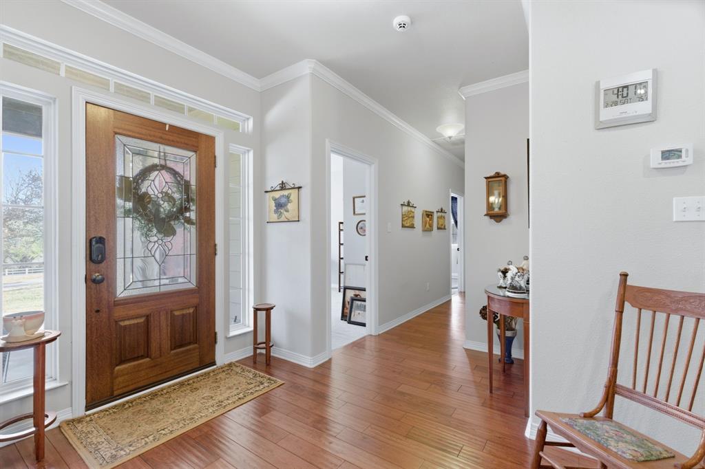 240 Johnson Bend Road Weatherford, TX 76088 - Photo 9 of 40 a view of a hallway with wooden floor and a livingroom