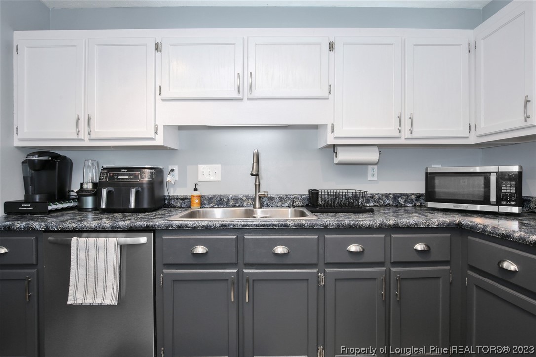 304 Kernstown Road Raeford, NC 28376 - Photo 13 of 33 a kitchen with stainless steel appliances granite countertop a stove a sink and a white cabinets