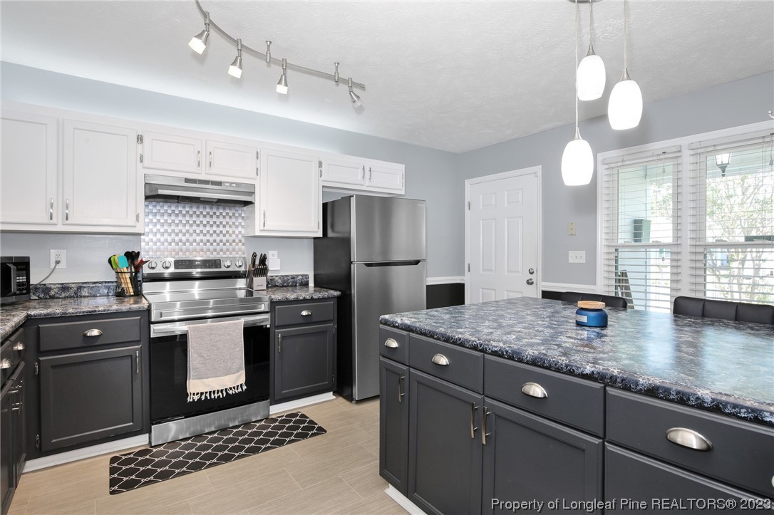 304 Kernstown Road Raeford, NC 28376 - Photo 14 of 33 a kitchen with stainless steel appliances granite countertop a sink dishwasher stove and refrigerator