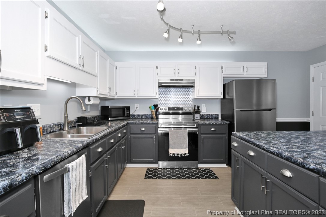 304 Kernstown Road Raeford, NC 28376 - Photo 15 of 33 a kitchen with stainless steel appliances granite countertop a sink stove and refrigerator