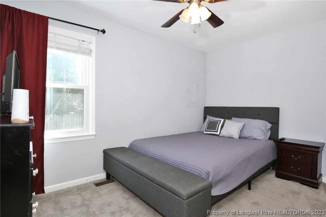 304 Kernstown Road Raeford, NC 28376 - Photo 17 of 33 a bedroom with a bed and a chandelier