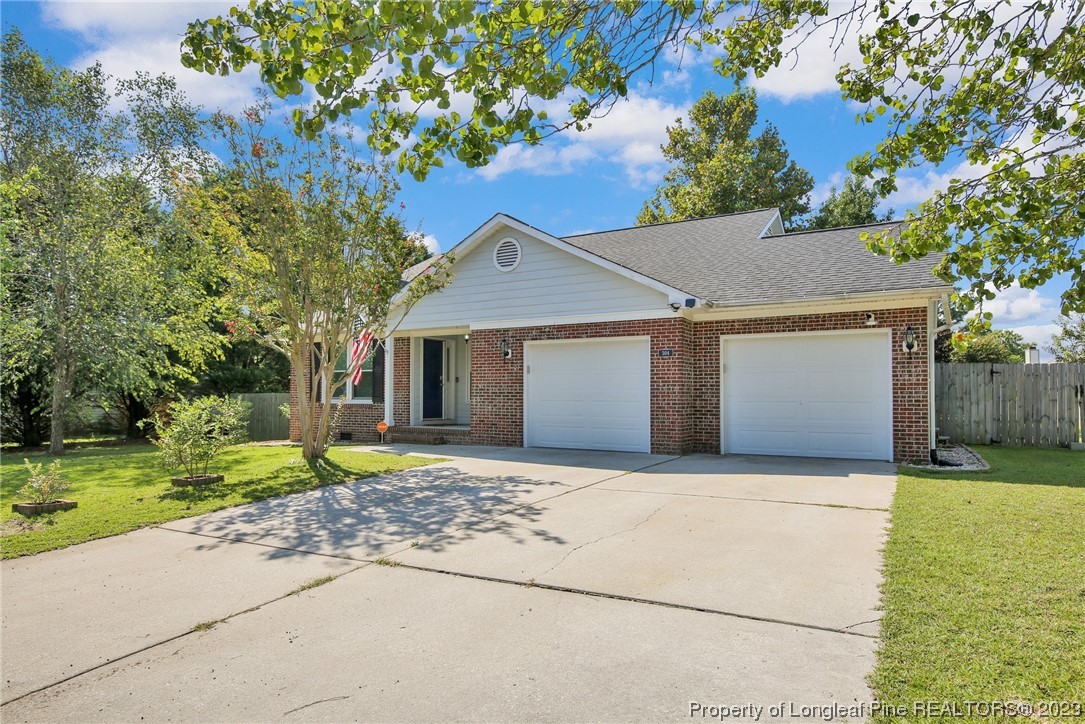 304 Kernstown Road Raeford, NC 28376 - Photo 2 of 33 a front view of a house with a yard and garage