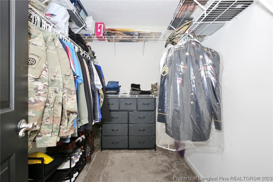 304 Kernstown Road Raeford, NC 28376 - Photo 24 of 33 a view of walk in closet with clothes and shoes