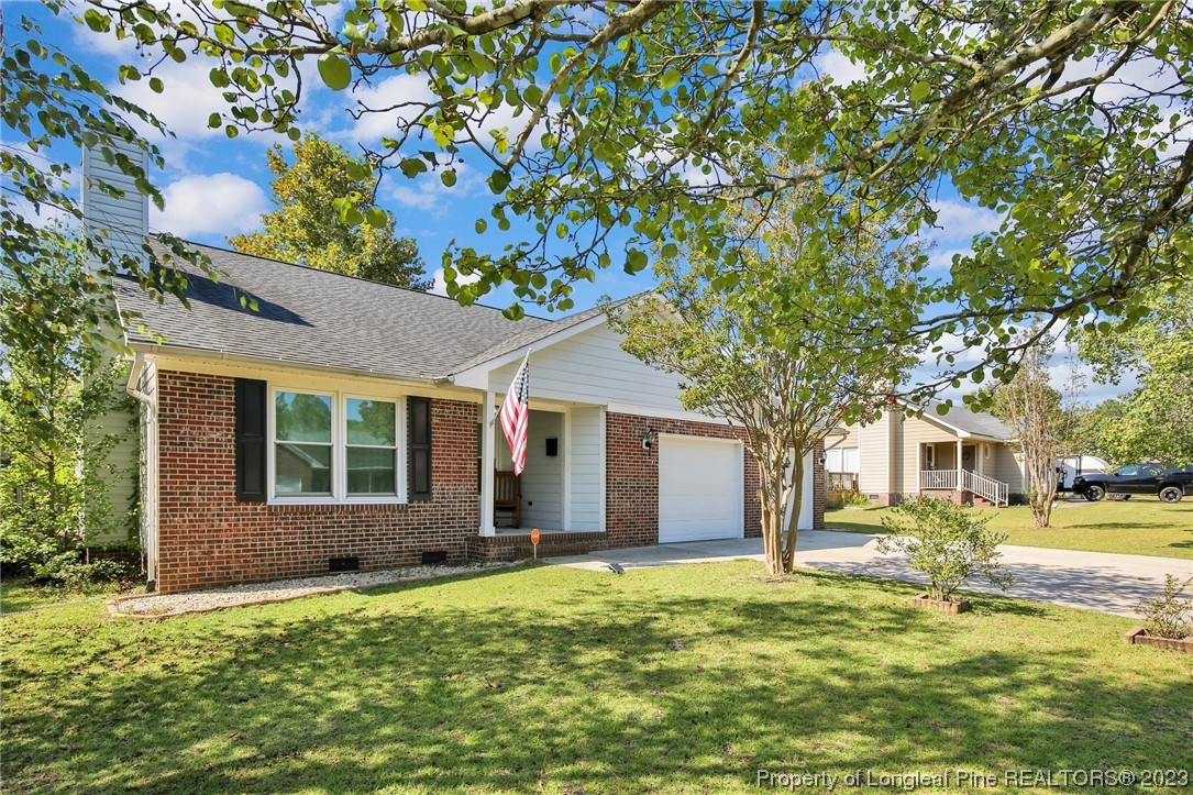 304 Kernstown Road Raeford, NC 28376 - Photo 3 of 33 a front view of a house with a yard garage and outdoor seating