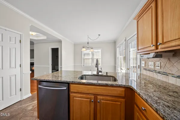 a kitchen with stainless steel appliances granite countertop a stove microwave and refrigerator