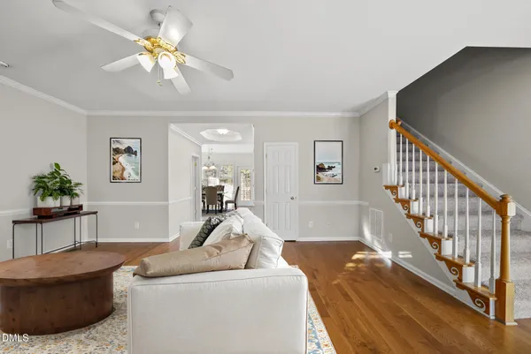 a view of an empty room with wooden floor fireplace and staircase
