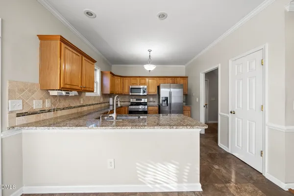 a kitchen with cabinets and refrigerator