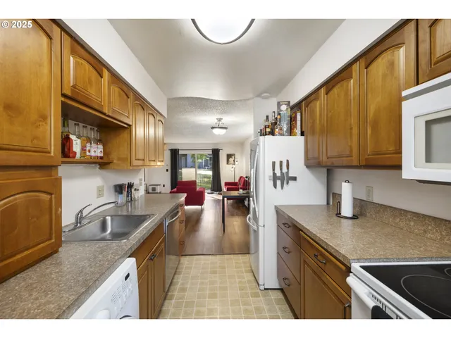 a kitchen with stainless steel appliances granite countertop a stove and cabinets