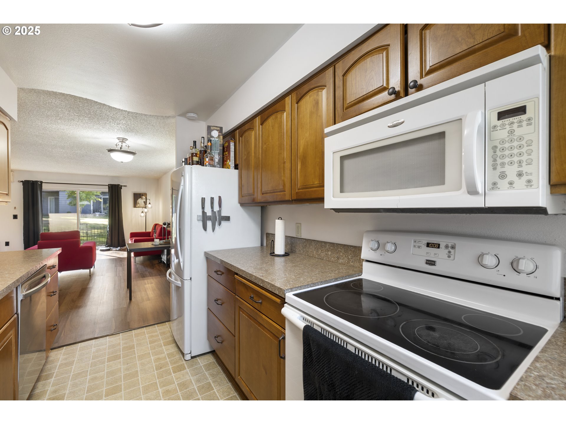 1418 Northeast Hogan Drive Gresham, OR 97030 - Photo 16 of 43 a kitchen with stainless steel appliances granite countertop a stove and cabinets