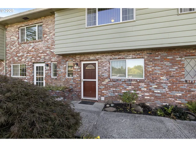 a view of a brick house with a yard