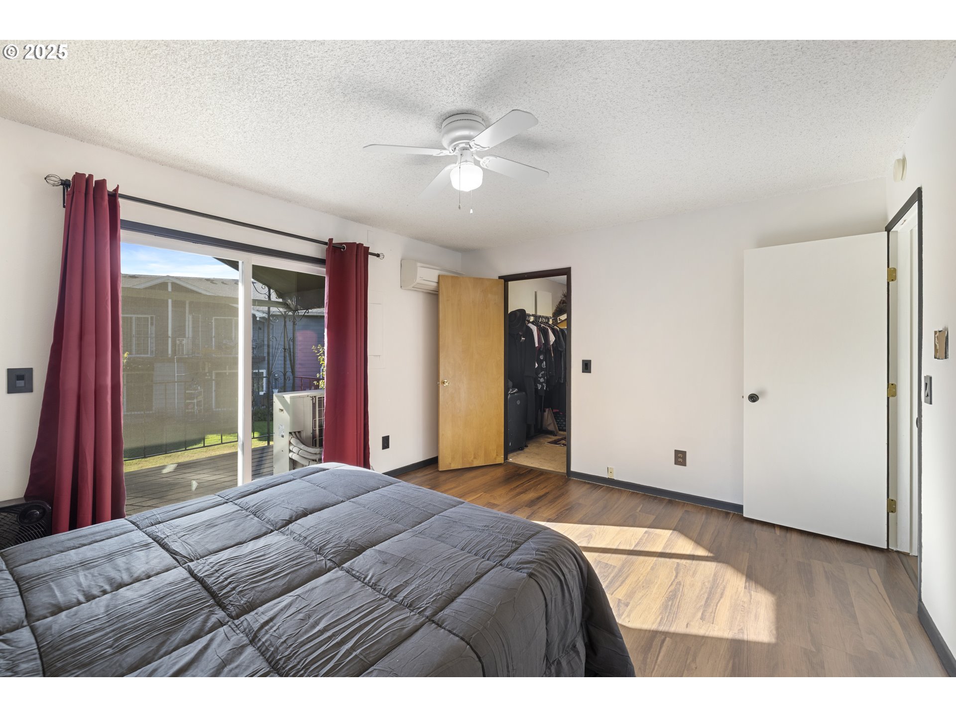 1418 Northeast Hogan Drive Gresham, OR 97030 - Photo 23 of 43 a bedroom with a large bed and a chandelier