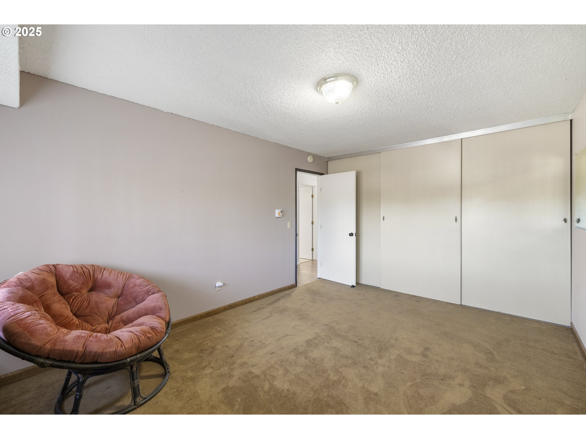 1418 Northeast Hogan Drive Gresham, OR 97030 - Photo 27 of 43 a view of an empty room with a ceiling fan and carpet