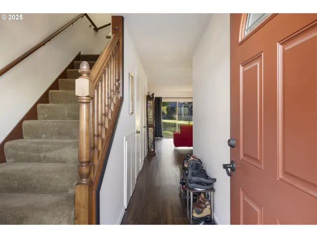 a view of entryway and hall with wooden floor