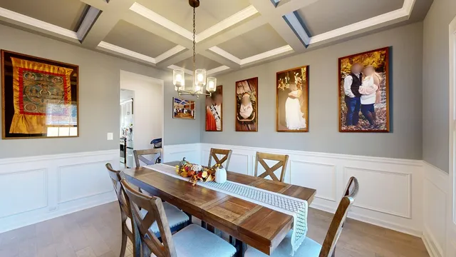 a living room with furniture a fireplace and chandelier