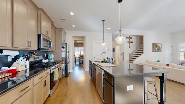 a living room with lots of furniture and a large window