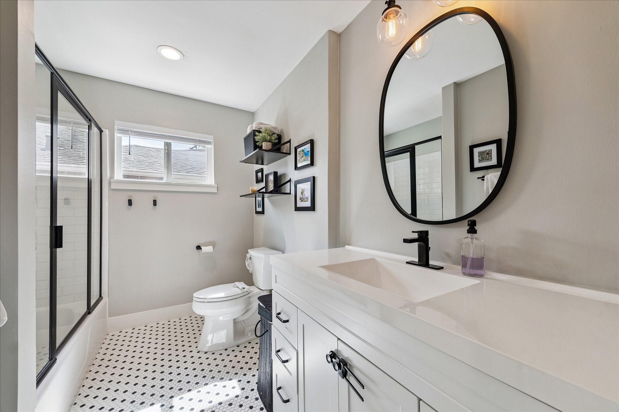 2203 Lamonte Lane Houston, TX 77018 - Photo 10 of 25 a bathroom with a sink a mirror a toilet and a shower
