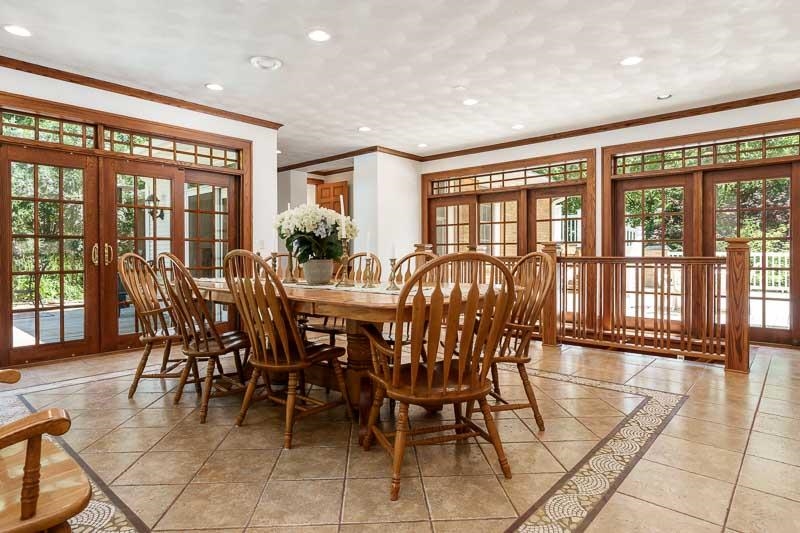 2716 Spring Creek Road Rockford, IL 61107 - Photo 6 of 76 a view of a dining room with furniture large windows and wooden floor
