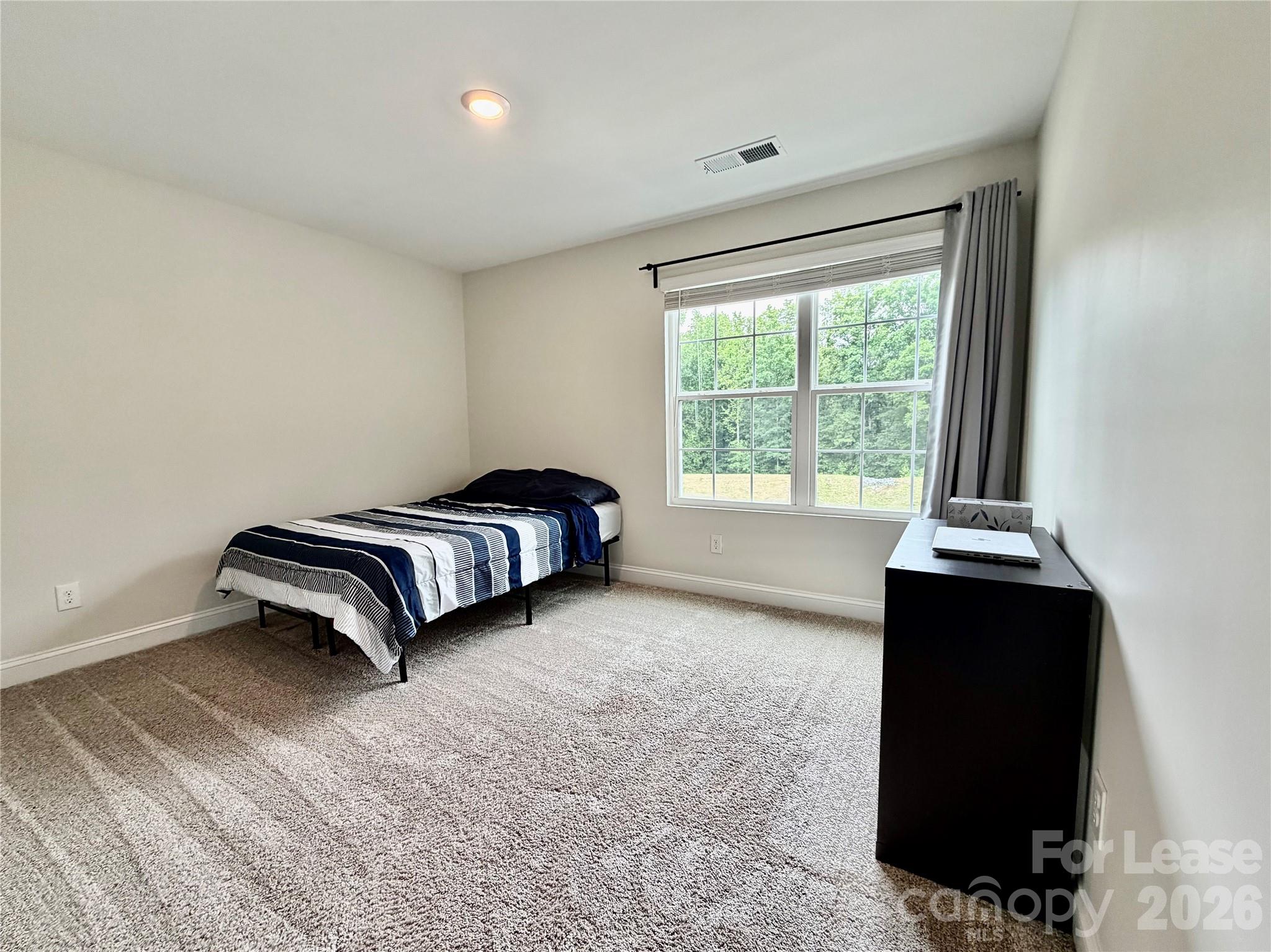 1220 Pecan Ridge Road Fort Mill, SC 29715 - Photo 15 of 25 a bedroom with a bed and a window