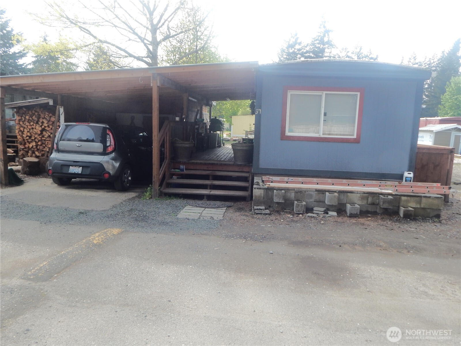 a view of backyard with car parked