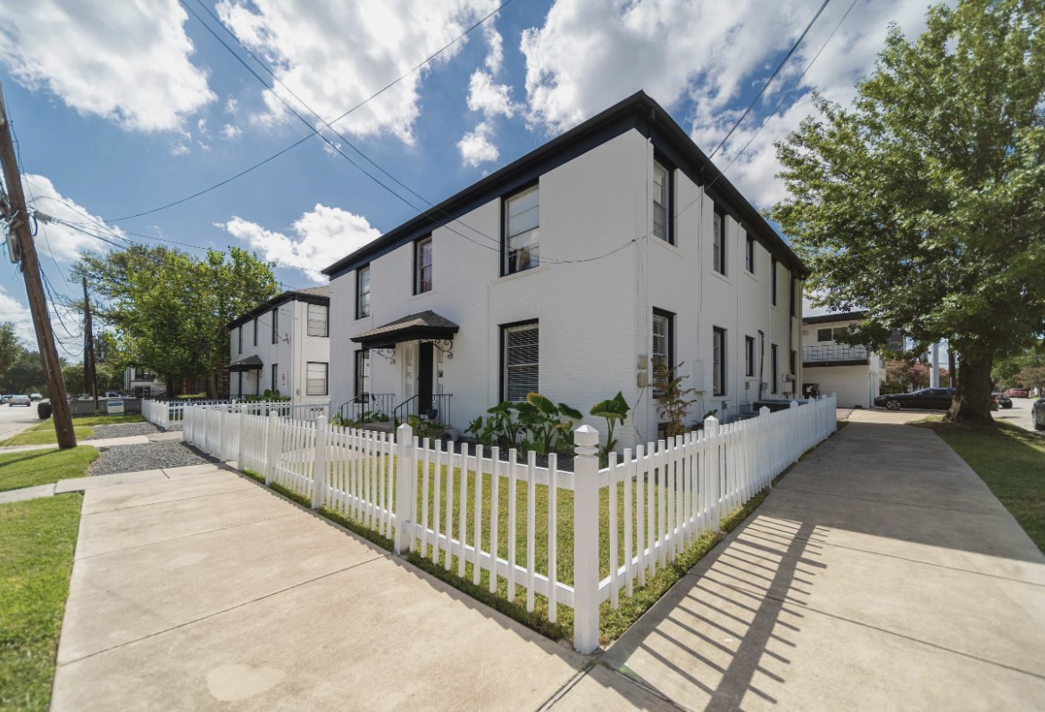 a front view of a house with wooden fence