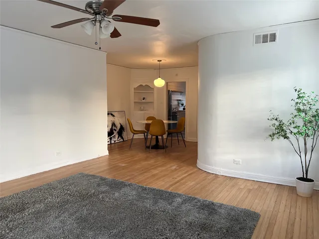 a large bedroom with a bed and a large mirror on the dresser