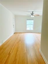 1849 West Main Street, Unit 15 Houston, TX 77098 - Photo 14 of 20 a view of empty room with wooden floor and fan
