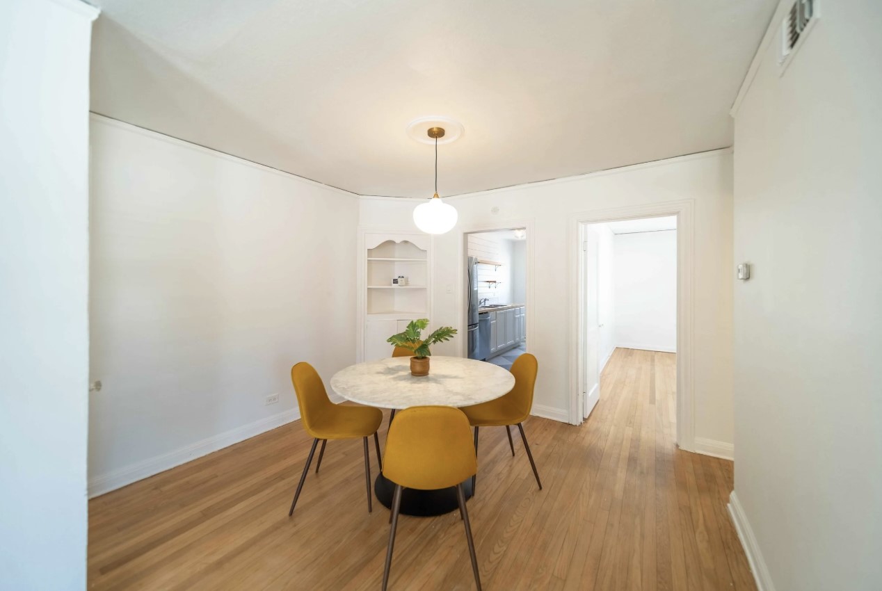 1849 West Main Street, Unit 15 Houston, TX 77098 - Photo 7 of 20 a view of a dining room with furniture and wooden floor