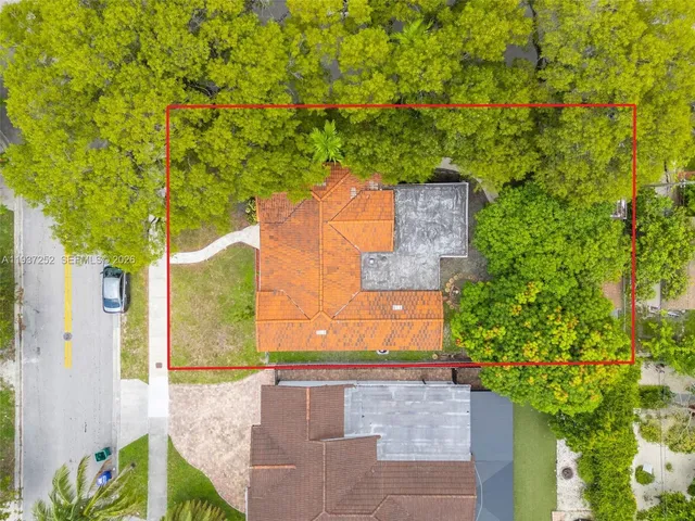 an aerial view of a house with a yard