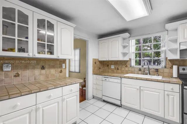 a kitchen with sink cabinets and windows