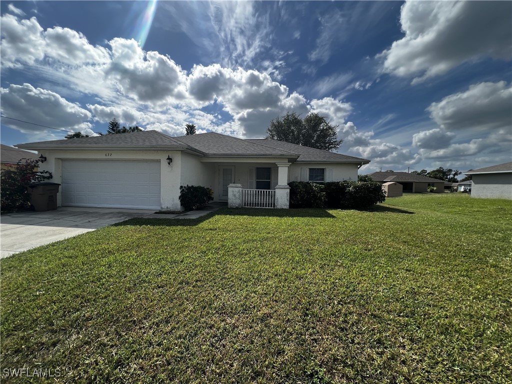 672 Homestead Road South Lehigh Acres, FL 33974 - Photo 1 of 35 a view of house with yard and entertaining space