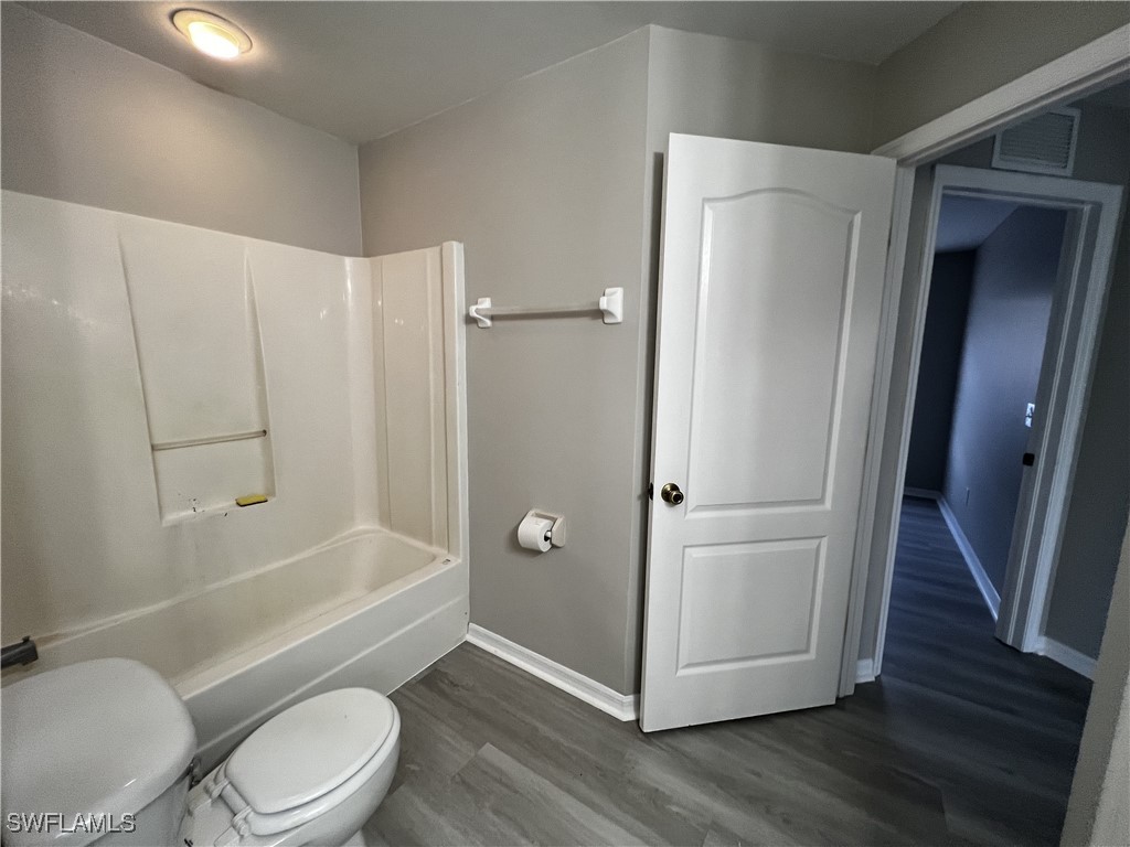 672 Homestead Road South Lehigh Acres, FL 33974 - Photo 25 of 35 a bathroom with a toilet and a shower