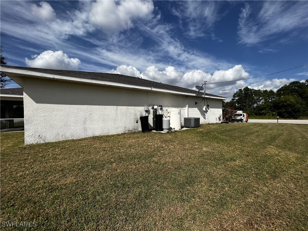 672 Homestead Road South Lehigh Acres, FL 33974 - Photo 33 of 35 a front view of a house with a yard